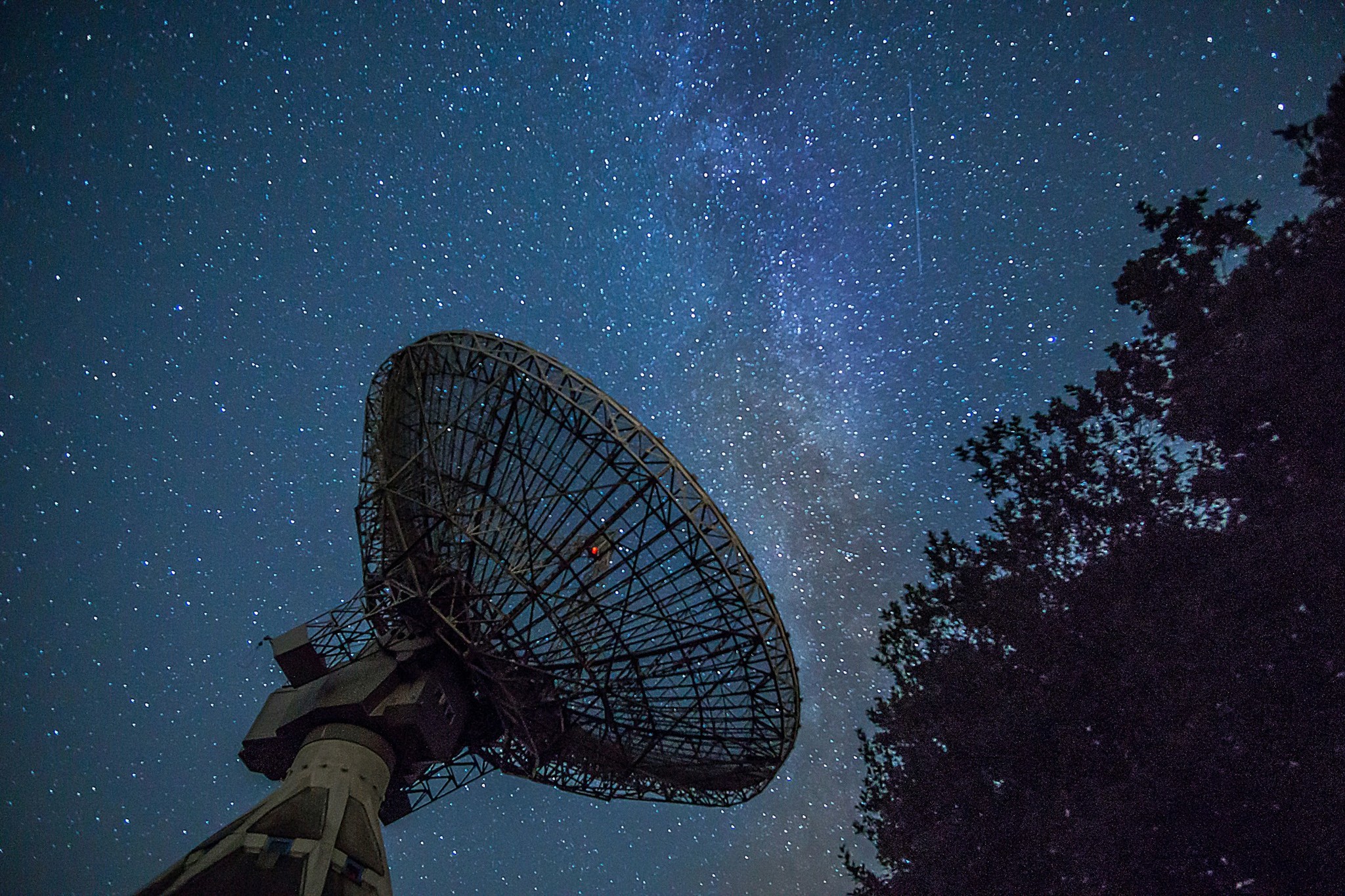 Satellite dish under a night sky